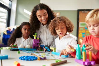 female-teacher-sitting-at-table-in-play-room-with-three-kindergartne-children-constructing.jpg female-teacher-sitting-at-table-in-play-room-with-three-kindergartne-children-constructing.jpg